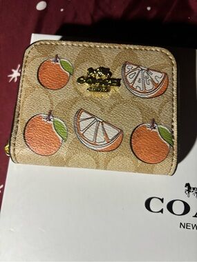 Coach Tan Signature Canvas Wallet with Orange Fruit Motif